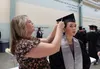 Graduating senior Magnolia Romano, gets a little help with her tassel before her graduation. Romano was also the recipient of the John Brown Lifelong Learning Scholarship Katie Stavick