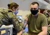 Tech. Sgt. Jerry Dye, a quality assurance specialist with the 3rd Maintenance Group, receives a COVID-19 vaccination at the Elmendorf Fitness Center on Joint Base Elmendorf-Richardson Jan. 14