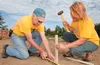 Wasilla Sunrise Rotary members Jerry Moses and Debbie Bushnell pound stakes into the ground in preparation for a new inclusive playground at Harold Newcomb Park in Wasilla. The playground is 