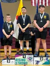 Palmer resident Isaac Hoffman, right, collects his silver medal in the boys under-15 bracket of the table tennis singles competition at the Arctic Winter Games on Tuesday. Keegan Qamanirq, of