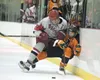 Wasilla senior defenseman William Harren checks West’s Max Osgood into the boards during Thursday’s quarterfinal game at the ASAA/First National Cup hockey championships at the Curtis C. Mena