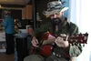 Justin Boot Rosseau, known by many simply as 'Boot,' plays a song for Bering Tea Company customers in Nome on Saturday, March 19. In the spring and summer, Boot spends most of his time in Tra