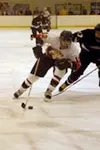 Houston High forward Wade Williams takes the puck past Colony's
Garrett Wilkens toward the Knight goal during the second period of
the Hawks' 8-3 win over the Knights on Friday. Photo by JERE