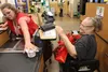 Fred Meyer cashier Elizabeth Chapman scans Julie Sain’s groceries in the Wasilla store Monday, July 2. The city of Wasilla’s ban on single use plastic grocery bags went into effect July 1. Ti