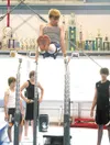 GREG JOHNSON/Frontiersman John Stogdill practices on the
parallel bars Sunday during a clinic with former U.S. Olympic
Gymnastics Team members at Denali Gymnastics and Fitness in
Wasilla.