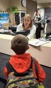 Christina Hansee greets a student at Snowshoe Elementary, answering a question as students make their way to their new classrooms during the first day of school on August 14. Katie Stavick/Fr