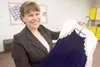 Shanna Omer holds the prom dress she wore when she was 16. Now
she is launching a prom dress drive aimed at helping teen girls
better afford the cost of wearing something beautiful to their o