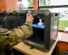 U.S. Air Force Airman 1st Class Christopher Young, a 3rd Munitions Squadron munitions support equipment maintenance crew chief, uses the 3D printer in the Arctic Spark Lab at Joint Base Elmen