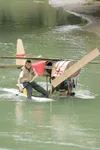 ROBERT DeBERRY/Frontiersman Hayden Seltenreich, 14, and his dad
float their barrel, cardboard and styrofoam float plane down the
Little-Su during the Houston Founder's Day Third Annual Little