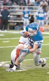 Palmer senior Dylan Myers gets tackled by a Juneau defender during Palmer’s 40-14 win Friday ROBERT DeBERRY/Frontiersman.com