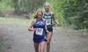 Palmer's Ruby Woodings runs ahead of Colony's Jordyn Block during the varsity girls race of the Colony Invitational Aug. 15 at Colony High School. Woodings finished sixth in the race Block wa