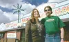 ROBERT DeBERRY/Frontiersman Dead Dog Saloon owners Jim and Lisa
Wirsbinske pose outside their Meadow Lakes bar. Tonight is the last
night the bar will be open for business. The bar was establ