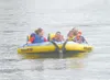 JEREMIAH BARTZ/Frontiersman Jessica Carter, left, Dillon
Hudzinski, Jarrod Nabinger and Ray Nabinger ride in a Sea Doo ski
tube during the Challenge Alaska Summer Splash, Saturday at Finger
L