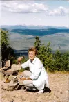 Mat-Su senior Dee Brown kneels down by an inuksuk, a Native-inspired landmark, in Dawson City, Yukon in August of 2007. Courtesy Dee Brown