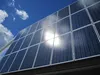 Sunlight reflects off solar panels lining the student recreation building at the University of Alaska Fairbanks campus on June 2, 2018. More solar arrays are set to be built with grant money 