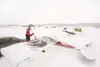 ROBERT DeBERRY/Frontiersman Peter Hakes sweeps snow off the wing
of his air plane Saturday at the Wasilla Airport. Hakes has had a
tie-down spot at the airport since 2004.