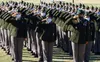 Drill Sergeant (Staff Sgt.) Hayon Ju, right, and her Soldiers in A Battery, 1st Battalion, 79th Field Artillery salute during the playing of the national anthem Nov. 16, 2020, at the battery’