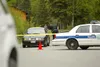 (ROBERT DeBERRY/Frontiersman) An officer with the Wasilla Police
department checks the trunk of a car leaving the area of a
stand-off Sunday near North Ptarmigan Place and Snowshoe Lane.