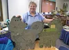 Debbie Waisanen, now a kindergarten and first grade teacher at Our Lady of the Valley Catholic School in Wasilla, holds up some wooden huskies her classes made in the early 1990s at Iditarod 