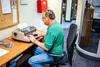 Gary Koskela, a buyer for the Mat-Su Borough, uses a typewriter to do his work. Several areas of the Borough, including many of the libraries are resorting to old-fashioned techniques to get 