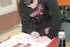 JEREMIAH BARTZ/Frontiersman Wasilla senior Jesse Bean signs a
Warrior basketball jersey that will commemorate his team winning
the large-schools state championship late last month. Since winn