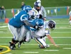 A pair of Palmer Moose stop a Lathrop drive for a first down during last week’s game at Machetanz Field at Palmer High. ROBERT DeBERRY/Frontiersman.com