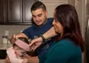 U.S. Air Force Staff Sgt. Ramses Alfonso, 673d Security Forces Squadron lead patrolman, adjusts his daughter’s headband while his mother holds his daughter in Anchorage, Alaska, Dec. 20, 2019