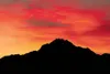 ROBERT DeBERRY/Frontiersman Pioneer Peak is silhouetted against
the orange and red of the sky as the sun begins to rise Thursday
morning.