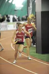 Junior Alyssa Hutchins hands the baton to junior Morgan Dampier
during the 3,200-meter relay event of the Big C Relays in Anchorage
on Saturday. The team, which also featured Jessica Pahkala 