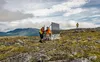 A crew sets up a mobile repeater between Kokhanok and Amakdedori during the summer of 2018. A bear guard is standing watch on the edge. Courtesy photo