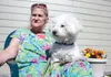 Chaz, a 10-year-old Bichon Poodle, sits calmly in the lap of his owner, 65-year-old Rhonda Modawell, behind Chinook Villa Apartments in Wasilla on Tuesday afternoon. The pair have been evicte