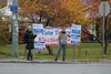 Supporters of Palmer City Council candidates hold signs in downtown Palmer Tuesday. Tim Rockey/Frontiersman