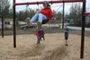 Astaria King (front), Braydon Davis (right) and JoJo Sayen use the swing at the new playground in Williwaw. Photos by Jacob Mann/Frontiersman