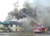 Firefighters use a ladder to access a fire that claimed a Palmer
building Saturday. No one was injured in the blaze. Photo by EOWYN
LeMAY IVEY/Frontiersman.
