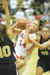 ROBERT DEBERRY/Frontiersman Wasilla senior Hillarie Putnam
drives the ball past South Anchorage guard Liza Spano, right,
during the Warriors’ first-round win over the Wolverines at Service
Hi