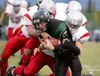 (ROBERT DeBERRY/Frontiersman) Colony Knight Matt Jaronik gets
taken down by three Wasilla defenders during the Knights win over
Wasilla Friday at Colony High School.