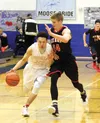 Wasilla senior Justin Lee works to get past Kenai's Garrett Fitt during a 57-50 overtime win over Kenai in the Northern Lights Conference Championships semifinals March 11, 2016, at Palmer Hi