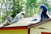 A World Changers crew sweeps moss off a Wasilla-area home
Wednesday morning at one of the eight World Changers sites. Photo
by Casey Ressler/Frontiersman.