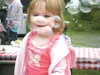 GREG JOHNSON/Frontiersman Emma Lucey, 20 months, is infatuated
by passing bubbles Saturday at the Mat-Su Midwifery’s salmon bake
in Wasilla.