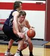 Houston's Kolby Taylor tries to get around Redington's Brian Amirualt near the base line during a 66-24 win over the Huskies Tuesday in Houston. Courtesy of Bruce Eggleston/matsusports.net
