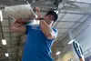 A volunteer lifts a bag of rice to put into a supplies bundle at Andersen Air Force Base, Guam, Dec. 7, 2019. Operation Christmas Drop 2019 placed 176 bundles onto 56 Micronesian islands acro