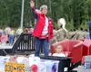 Wasilla Mayor Glenda Ledford waves to the crowd as she rides in the Wasilla Police Department float during the July 4 parade in 2023. Jeremiah Bartz/Frontiersman