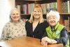 Lorraine M. Kirker, Cheryl Homme and Lynette A. Lehn pose for a photo together in Alaskana Books. The collection has been sold to a new owner and the three friends will be on hand Fridays thr
