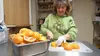 Lynette Ortolano slices oranges at the Boys and Girls Club kitchen Friday. Ortelano has successfully rebuilt inventory and equipment at the kitchen since several hundred dollars of utensils a