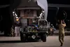 U.S. Air Force Airman 1st Class Chase Smith, right, 8th Airlift Squadron loadmaster, marshals a K-loader toward a C-17 Globemaster III, assigned to Joint Base Lewis-McChord, Washington, at Tr