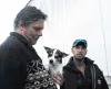 Waymon Price holds Mousie the terrier as PriceÕs excavation
business employee Joe Comoza looks on. Photo by STEVE
KADEL/Frontiersman.