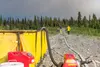 Andrew Severs and Scott Belue, both of the Gakona Volunteer Fire Department, walk down a long driveway to check on the preposition sprinklers, supplied by 1,000-gallon water reservoirs, that 