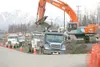 ROBERT DeBERRY/Frontiersman Dump trucks line up to haul dirt
away at Midtown Drive and the Palmer-Wasilla Highway Friday
afternoon. Road construction crews are preparing to put in a
turning l