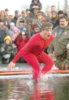 ROBERT DeBERRY/Frontiersman Denmark exchange student Andreas
Pedersen takes a plunge into the freezing water of Finger Lake
Saturday during the fourth annual Mat-Su Polar Plunge.