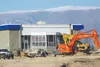 Workers prepare to lift up the Tesoro station building at the intersection of Seward Meridian Parkway and Palmer-Wasilla Highway for relocation and recycling. This photo was taken last week, 